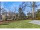 Expansive backyard with a lush lawn, brick patio, and mature trees along the fence line at 3909 Enclave Way, Tucker, GA 30084