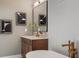 Close up of soaker tub with gold hardware, wall art, and herringbone wall paneling at 3909 Enclave Way, Tucker, GA 30084