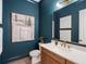 Chic bathroom with a wood vanity, marble countertop, gold hardware, and modern art at 3909 Enclave Way, Tucker, GA 30084