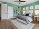 A well-lit bedroom with a queen bed, wall art, and hardwood floors at 3909 Enclave Way, Tucker, GA 30084