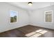 Cozy bedroom with hardwood floors, bright white walls, and natural light from two large windows at 3909 Enclave Way, Tucker, GA 30084