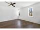 Bedroom with hardwood floors, two windows, ceiling fan, and white walls at 3909 Enclave Way, Tucker, GA 30084