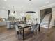 Open-concept dining area with modern table and chairs, steps to an open kitchen, and sleek hardwood floors at 3909 Enclave Way, Tucker, GA 30084