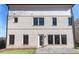 Rear view of a two-story brick home with multiple windows and a walk-out patio at 3909 Enclave Way, Tucker, GA 30084