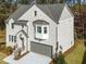 Elegant exterior of a two-story house featuring light-colored brick and lush green landscaping at 3909 Enclave Way, Tucker, GA 30084