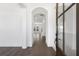 Inviting foyer with hardwood floors, archway, and glass paneled door at 3909 Enclave Way, Tucker, GA 30084