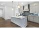 Bright kitchen with a central island, modern appliances, stylish lighting, and a blue backsplash at 3909 Enclave Way, Tucker, GA 30084