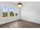 Bright room with hardwood floors, large windows, and a stylish pendant light at 3909 Enclave Way, Tucker, GA 30084