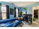 Bright bedroom with blue walls, unique decor, and natural light from the windows at 4283 Northwind Dr, Ellenwood, GA 30294