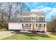 Charming two-story home featuring a welcoming front porch, attached garage and manicured lawn at 4283 Northwind Dr, Ellenwood, GA 30294