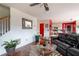 Open-concept living room with hardwood floors, zebra print rug, and a black leather sofa at 4283 Northwind Dr, Ellenwood, GA 30294