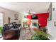 Bright living room featuring hardwood floors, a fireplace, and vibrant red accent wall at 4283 Northwind Dr, Ellenwood, GA 30294