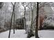 Back of home with screened porch and trees, captured in the winter after snowfall at 445 Edenbrooke Way, Roswell, GA 30075