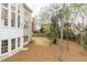 Large backyard with a playset, mature trees, and privacy fence on a sunny day at 445 Edenbrooke Way, Roswell, GA 30075