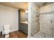 Updated bathroom with tiled walk-in shower featuring pebble accents and wooden floors at 445 Edenbrooke Way, Roswell, GA 30075