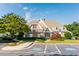 Community clubhouse with accessible parking, manicured landscaping, and brick facade at 445 Edenbrooke Way, Roswell, GA 30075