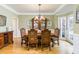 Elegant dining room with hardwood floors, a bay window, and crown molding at 445 Edenbrooke Way, Roswell, GA 30075