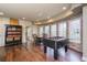 Spacious game room featuring brick wall accent, foosball table, and hardwood floors at 445 Edenbrooke Way, Roswell, GA 30075