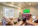 Cozy living room with coffered ceiling, TV, leather furniture, and French doors at 445 Edenbrooke Way, Roswell, GA 30075