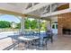 Outdoor seating area featuring tables and chairs next to a brick outdoor fireplace at 445 Edenbrooke Way, Roswell, GA 30075