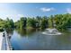 Community pond featuring a fountain, mature trees, and multiple residential homes at 445 Edenbrooke Way, Roswell, GA 30075