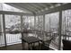 Snowy view from the screened-in porch with outdoor furniture and black metal railing at 445 Edenbrooke Way, Roswell, GA 30075