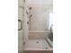 Modern walk-in shower with a glass door, built-in bench, and stylish tile work at 445 Edenbrooke Way, Roswell, GA 30075