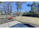 Large backyard with seating around a fire pit at 212 Sunset Hills Dr, Norcross, GA 30071