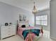 This bedroom features a modern chandelier, a double window, and neutral tones at 212 Sunset Hills Dr, Norcross, GA 30071