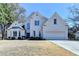 Charming white painted two-story home with well-manicured lawn and attached two car garage at 212 Sunset Hills Dr, Norcross, GA 30071