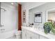 Well-lit bathroom featuring a shower-over-tub, white vanity, and decor with warm accents at 2520 Mountain Ash Se Ln # 109, Smyrna, GA 30080