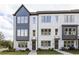 Modern townhome showcases a stylish facade with large windows, painted brick, and professionally landscaped yard at 2520 Mountain Ash Se Ln # 109, Smyrna, GA 30080