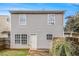 Backyard features a back door, two windows, a small patio, and a partial fence at 256 Coral Cir, Mcdonough, GA 30253