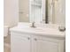 Bathroom featuring a white vanity, mirror, modern sink faucet, and neutral color scheme at 256 Coral Cir, Mcdonough, GA 30253