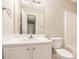 Bright bathroom features a white vanity, sink, faucet, mirror, toilet and shower/tub at 256 Coral Cir, Mcdonough, GA 30253