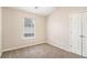 Bright bedroom features neutral walls, carpet, natural light from a window, and a closet at 256 Coral Cir, Mcdonough, GA 30253