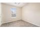 Bedroom features neutral walls, carpet, a ceiling fan, and natural light from a window at 256 Coral Cir, Mcdonough, GA 30253