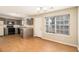 Eat-in kitchen with modern appliances, granite countertops, and wood-look flooring, creating a stylish and functional space at 256 Coral Cir, Mcdonough, GA 30253