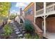 Backyard featuring an outdoor stairway, stone walkway, and a brick foundation at 765 Glengate Pl, Atlanta, GA 30328