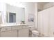 Well-lit bathroom with a vanity, large mirror, and shower, providing a functional and stylish space for personal care at 765 Glengate Pl, Atlanta, GA 30328