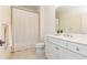 Well-lit bathroom showcasing a double vanity, tile floors, and a shower-tub combination at 765 Glengate Pl, Atlanta, GA 30328
