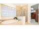 Bathroom features a soaking tub, glass enclosed shower, and tile flooring at 765 Glengate Pl, Atlanta, GA 30328