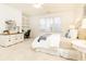 Bright bedroom featuring neutral decor, comfortable bedding, and an adjacent home office, creating a serene and productive space at 765 Glengate Pl, Atlanta, GA 30328