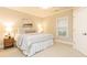 Cozy bedroom with neutral colors, a window, and a wooden nightstand at 765 Glengate Pl, Atlanta, GA 30328