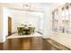 Elegant dining room featuring hardwood floors, wainscoting, modern lighting, and French doors at 765 Glengate Pl, Atlanta, GA 30328