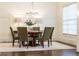 Formal dining room features paneled walls, modern chandelier, and seating for six, offering an elegant space at 765 Glengate Pl, Atlanta, GA 30328