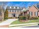 Beautiful brick home featuring mature landscaping, black shutters, a manicured lawn, and a private driveway at 765 Glengate Pl, Atlanta, GA 30328