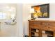 Hallway featuring hardwood floors, a decorative table, and artwork, offering a glimpse into the serene bedroom beyond at 765 Glengate Pl, Atlanta, GA 30328