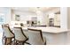 Spacious kitchen features white cabinets, stainless steel appliances, and a large island with seating at 765 Glengate Pl, Atlanta, GA 30328