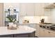 Modern kitchen features stainless steel appliances, white cabinets, and a dark brown center island with a white countertop at 765 Glengate Pl, Atlanta, GA 30328